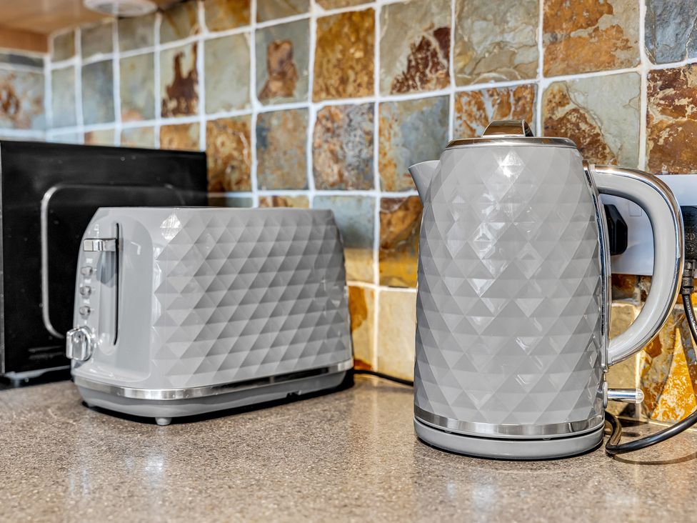 A kettle and toaster on a kitchen countertop at Stoke Townhouse in Stoke-on-Trent