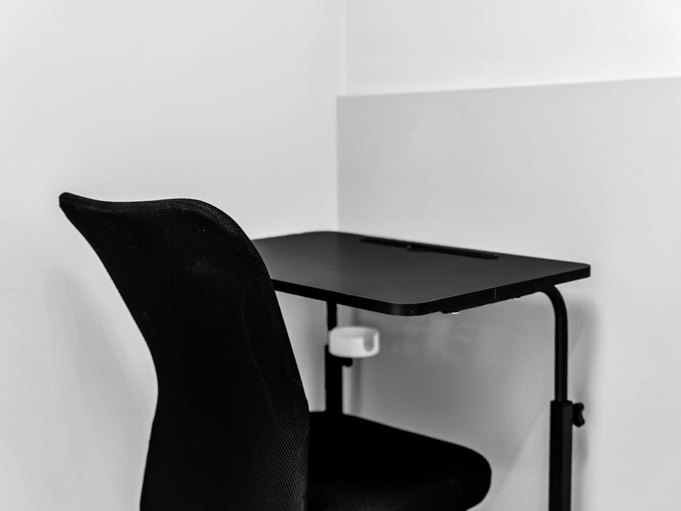 A chair and desk in an office at Stoke Townhouse Stoke-on-Trent