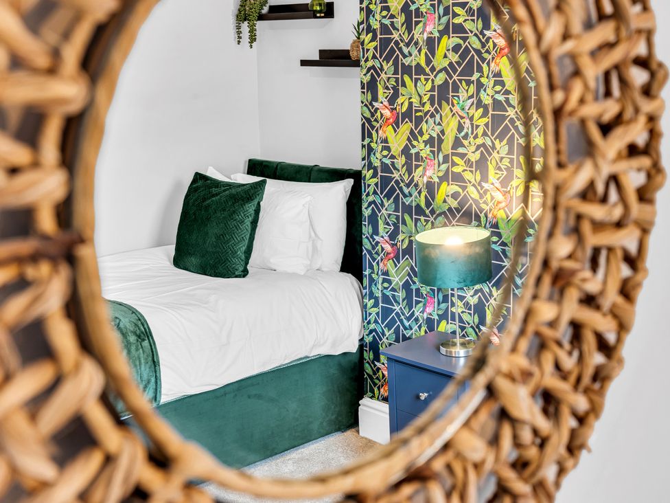 A bedroom with a bed and lamp at Stoke Townhouse in Stoke-on-Trent