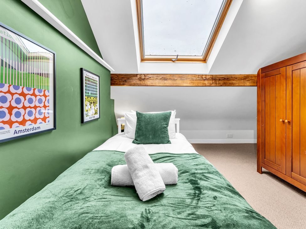 A bedroom with a bed and wardrobe at Stoke Townhouse in Stoke-on-Trent