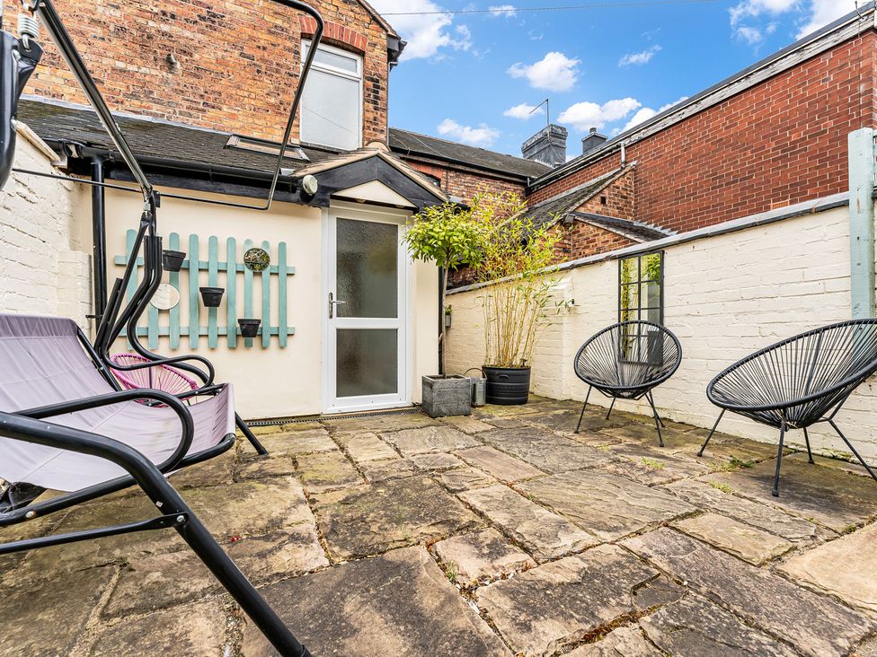 A garden with a swing seat and planters at Stoke Townhouse in Stoke-on-Trent