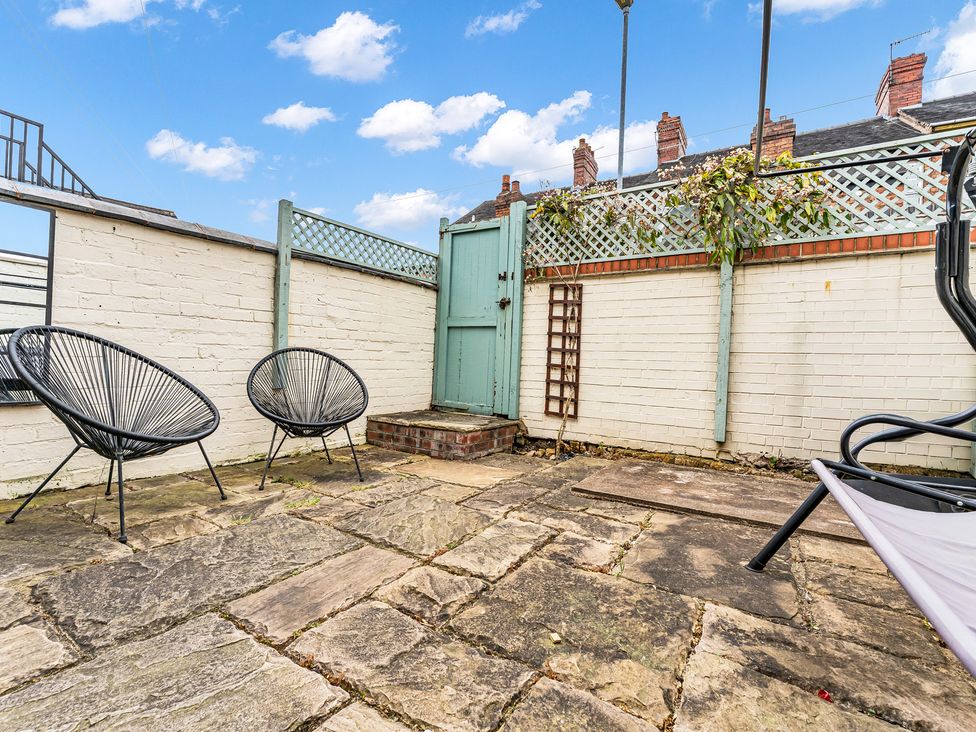 An outdoor area with chairs and a door at Stoke Townhouse in Stoke-on-Trent