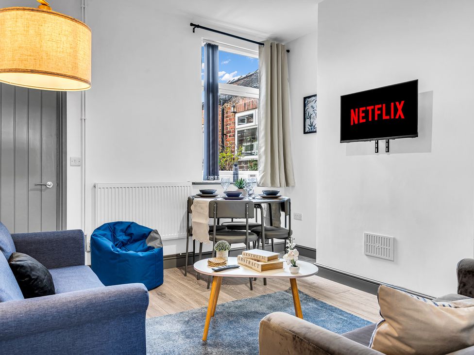 A living room with a television and seating at Victoria House, Stoke on Trent