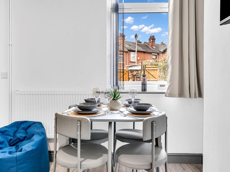 A dining area with a table set for meals at Victoria House, Stoke on Trent