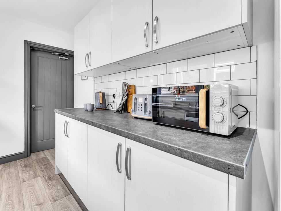 A kitchen with cabinet and appliances at Victoria House, Stoke on Trent
