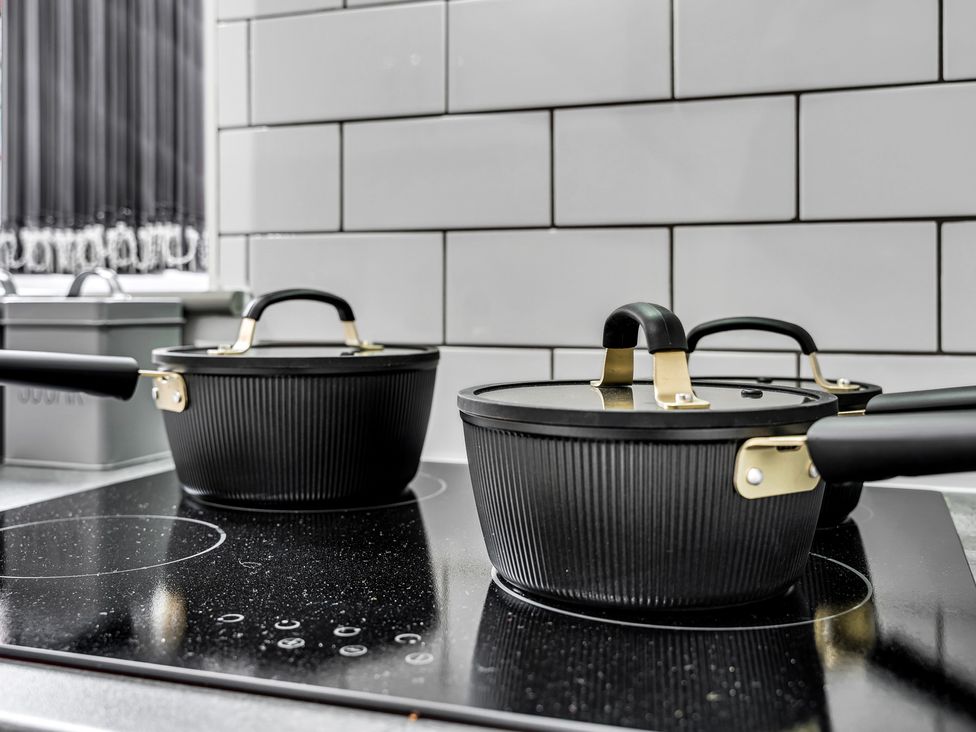 Cooking pots on an induction cooktop in a kitchen at Victoria House, Stoke on Trent