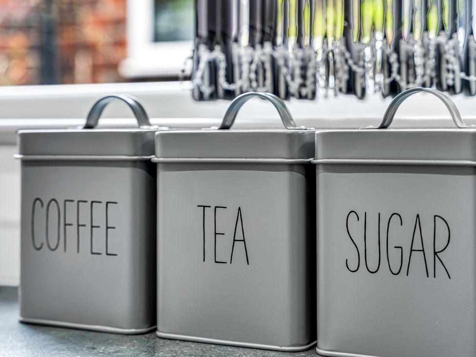 Three canisters labeled coffee, tea, and sugar in a kitchen at Victoria House, Stoke on Trent