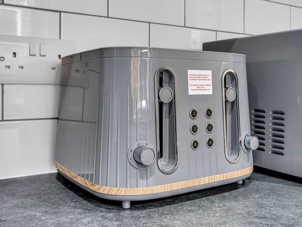 A toaster with control knobs in a kitchen at Victoria House, Stoke on Trent