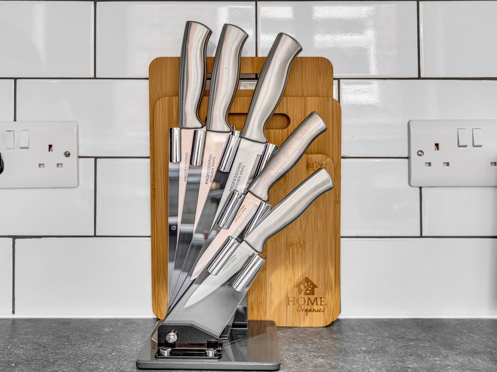A knife block with knives and a chopping board in a kitchen at Victoria House, Stoke on Trent