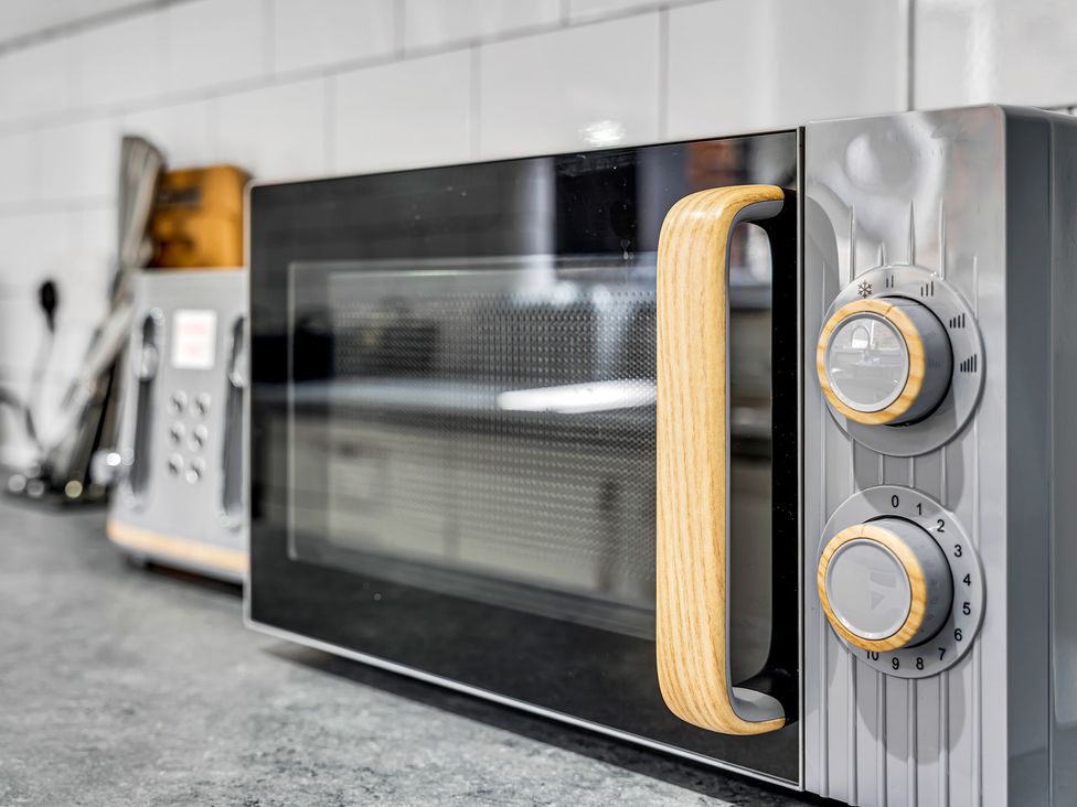 A microwave on a kitchen counter at Victoria House, Stoke on Trent