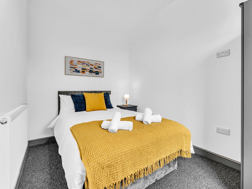 A bedroom with a double bed and a bedside table at Victoria House, Stoke on Trent