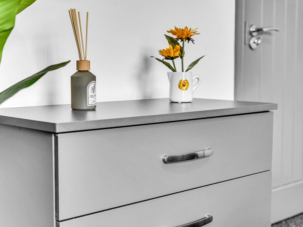 A drawer with a diffuser and flower pot at Victoria House, Stoke on Trent
