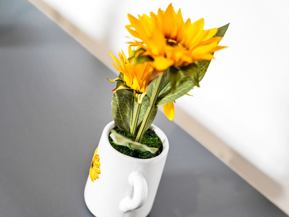 A flower arrangement in a mug on a table at Victoria House, Stoke on Trent