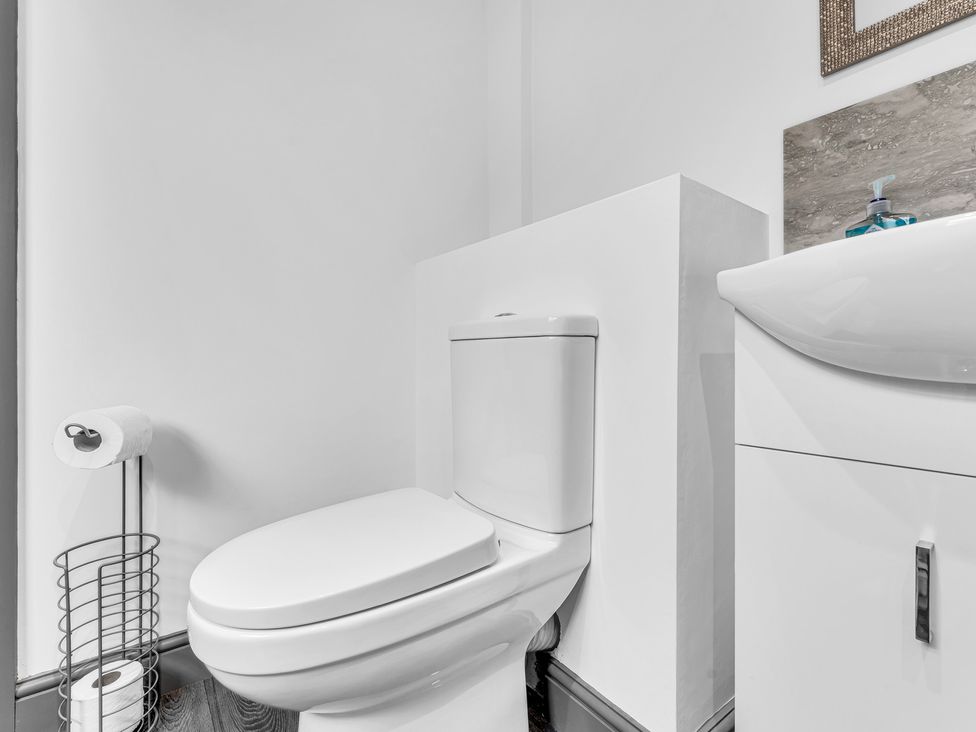 A bathroom with a toilet and sink at Victoria House, Stoke on Trent