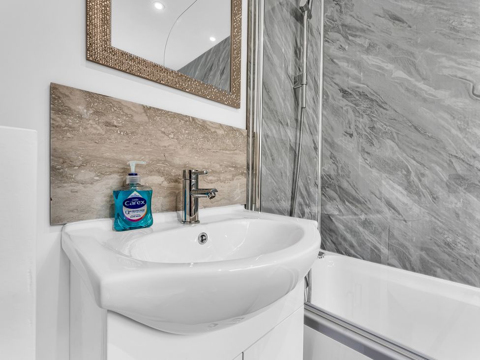 A bathroom with a sink and shower at Victoria House, Stoke on Trent