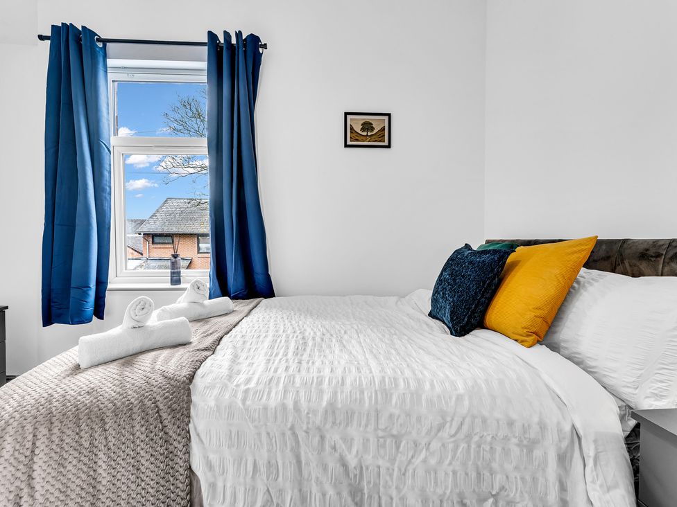 A bedroom with a bed and pillows at Victoria House, Stoke on Trent