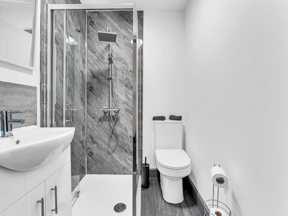 A bathroom with a shower, sink, and toilet at Victoria House, Stoke on Trent