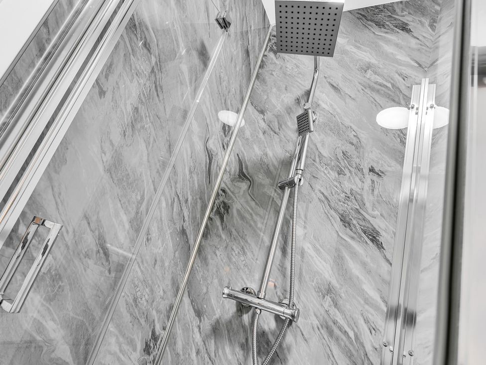 A shower with a shower head and faucet in a bathroom at Victoria House, Stoke on Trent