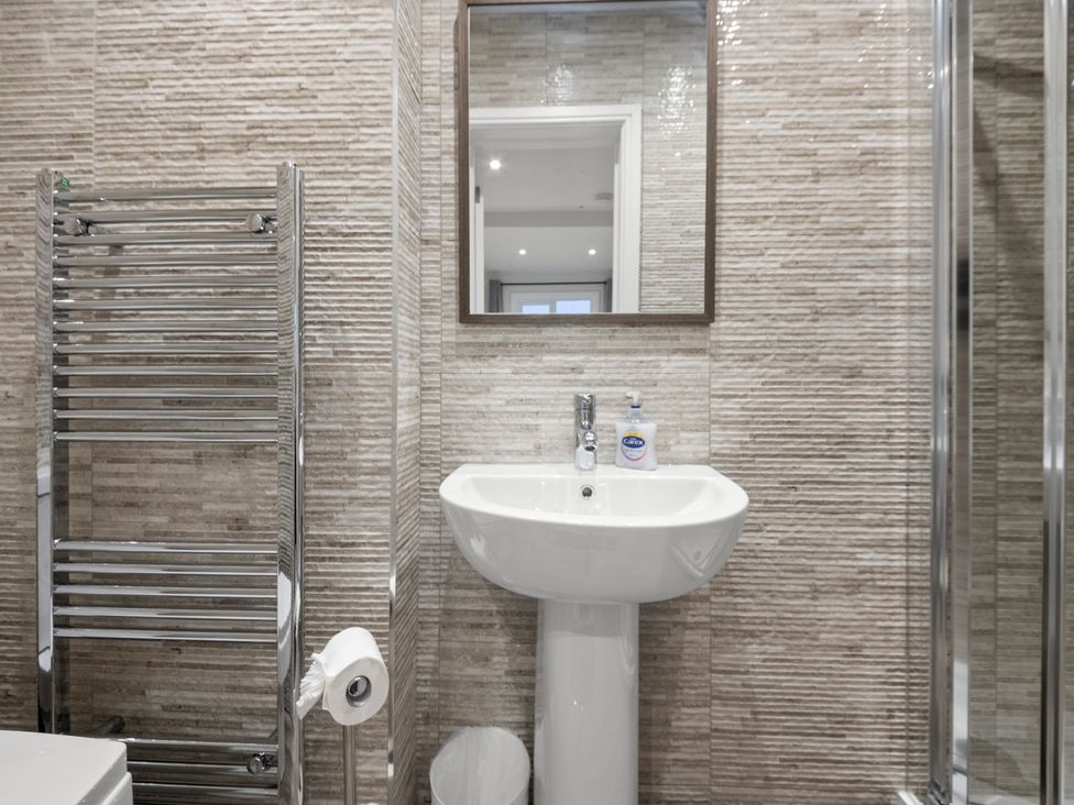 A bathroom with a sink and towel rail at Oxford City Stay – Cooper House in Oxford