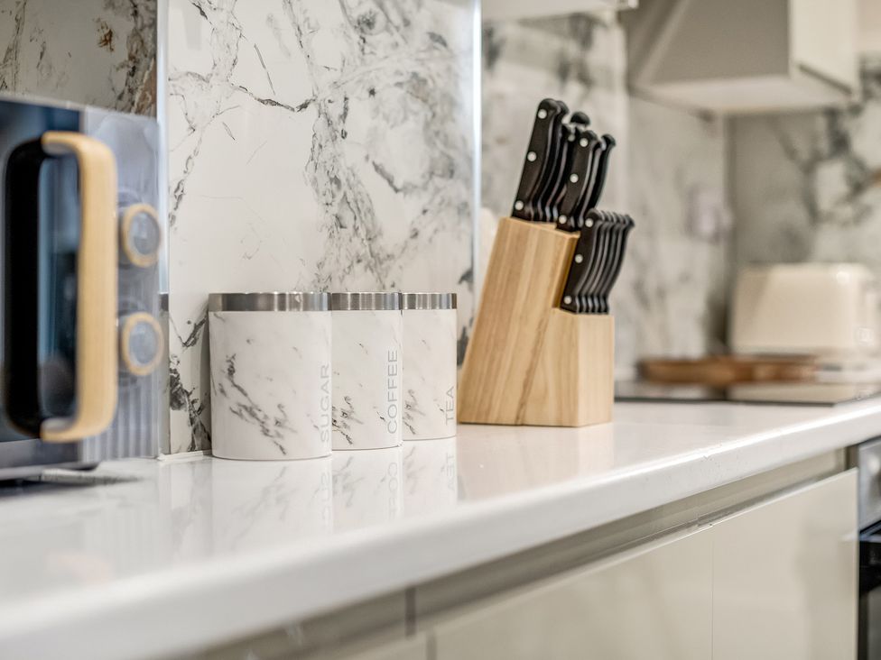 A kitchen countertop with canisters and a knife block at Oxford City Stay – Cowley House, Oxford