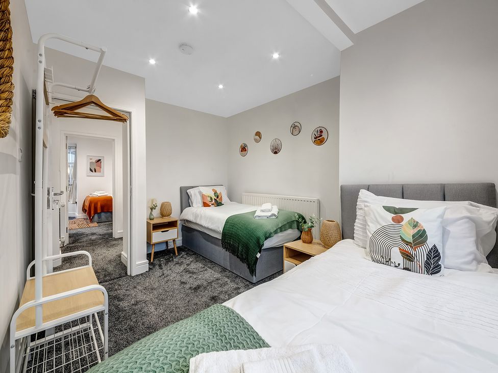 A bedroom with two beds and a wardrobe at Oxford City Stay – Cowley House in Oxford