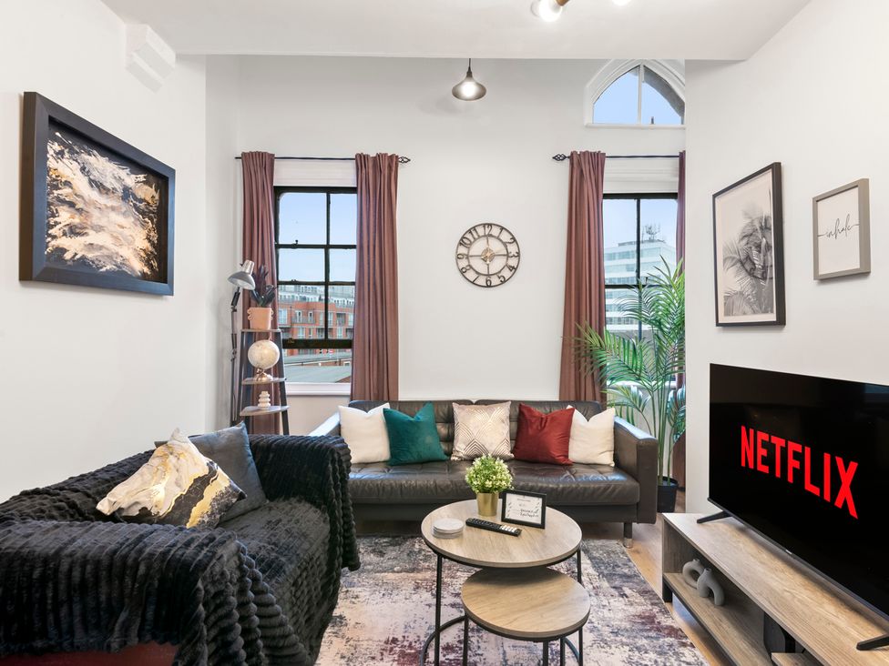 A living room with a sofa and coffee table at The Hallmark Birmingham Flat Birmingham