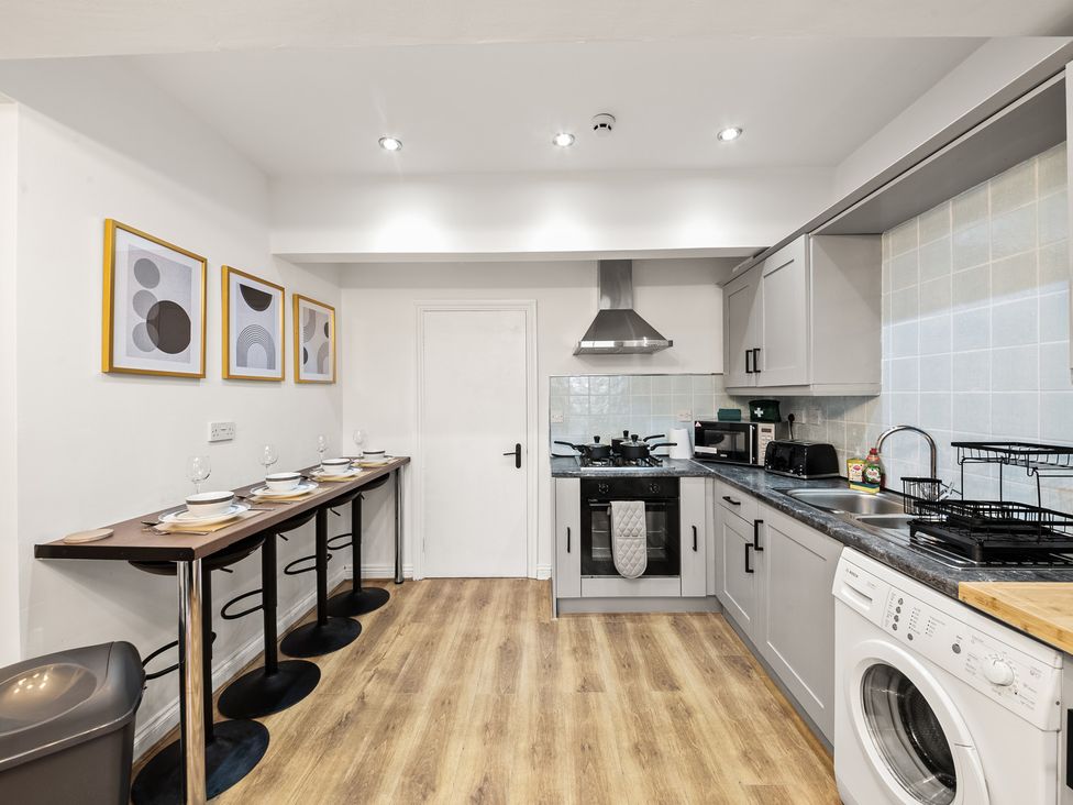 A kitchen with appliances and seating at The Hallmark Birmingham Flat Birmingham