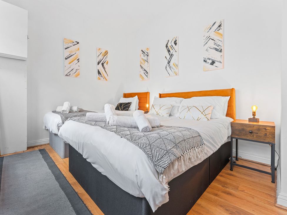 A bedroom with two beds and wall art at The Hallmark Birmingham Flat Birmingham