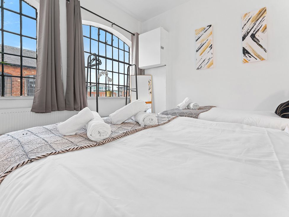 A bedroom with a bed and towels at The Hallmark Birmingham Flat Birmingham