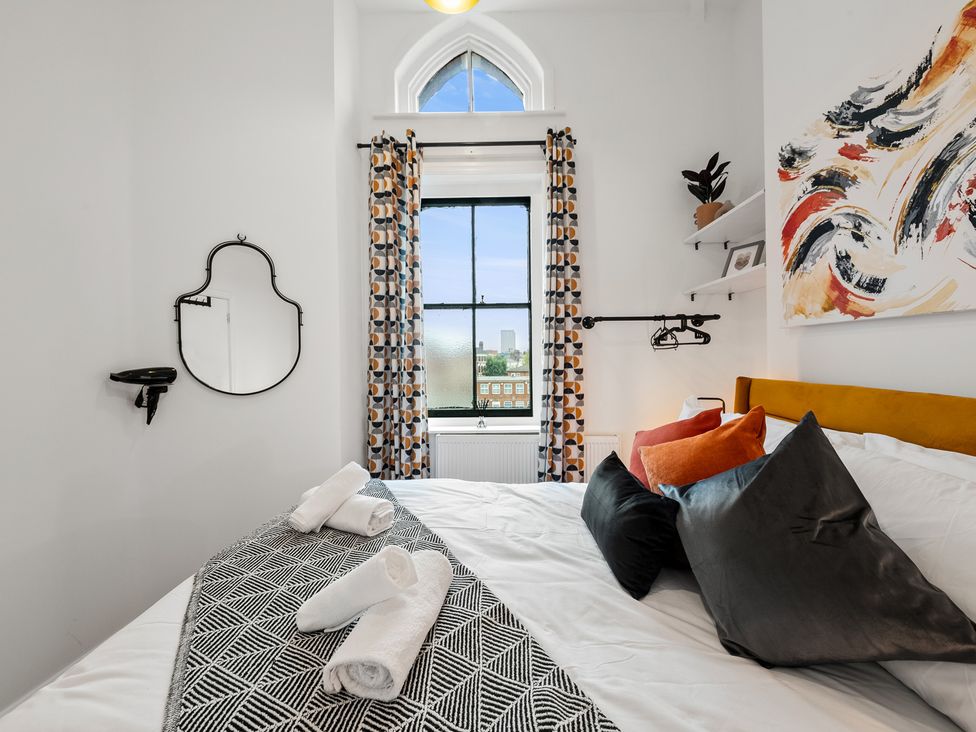 A bedroom with a bed and window at The Hallmark Birmingham Flat Birmingham