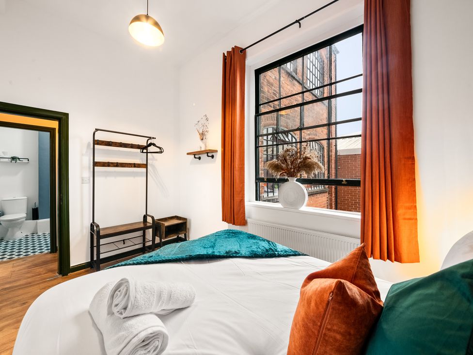 A bedroom with a bed and a window at The Jewel Box Birmingham City Apartment Birmingham