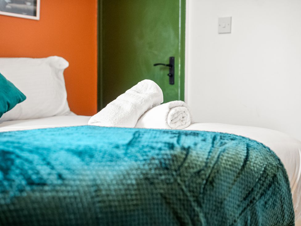 A bedroom with a bed and towels at The Jewel Box Birmingham City Apartment Birmingham