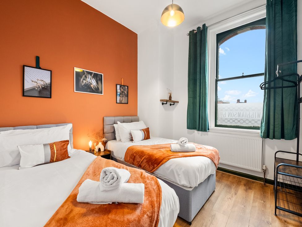 A bedroom with two beds and a window at The Jewel Box Birmingham City Apartment Birmingham