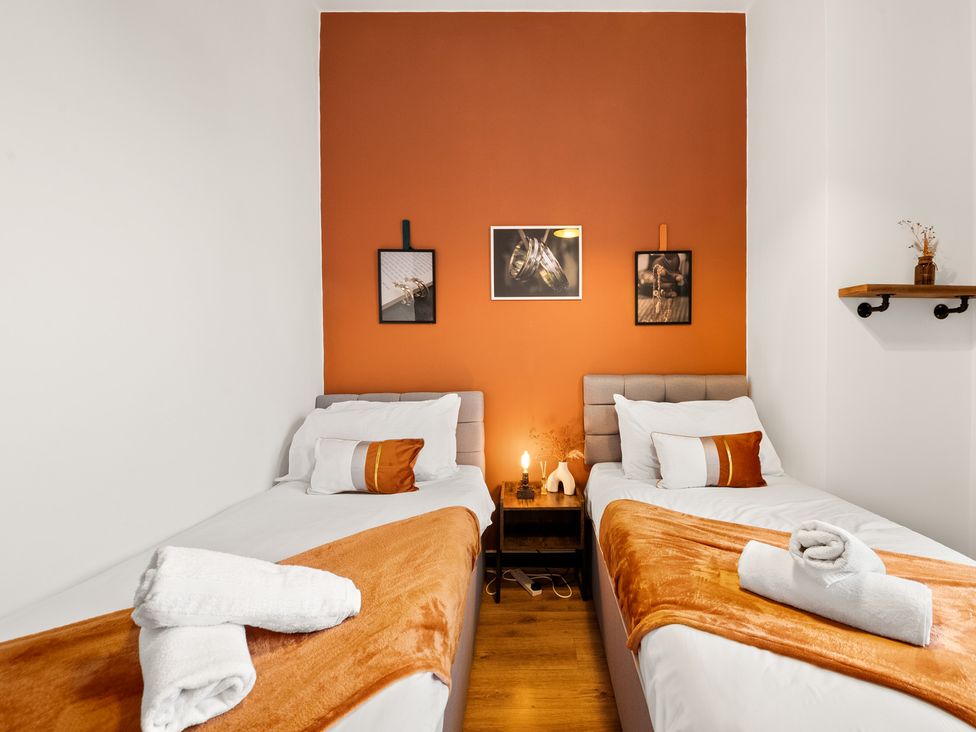 A bedroom with two beds and wall art at The Jewel Box Birmingham City Apartment Birmingham