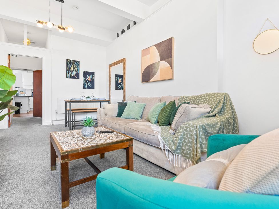 A living room with a sofa and coffee table at The Gilder Birmingham City Apartment Birmingham