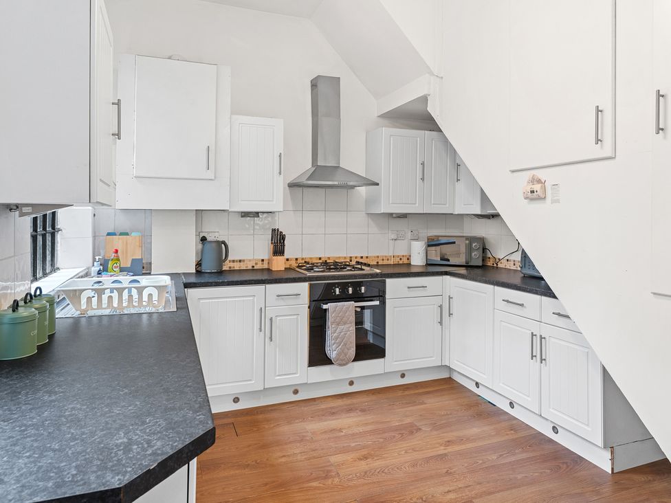 A kitchen with a stove and microwave at The Gilder Birmingham City Apartment Birmingham
