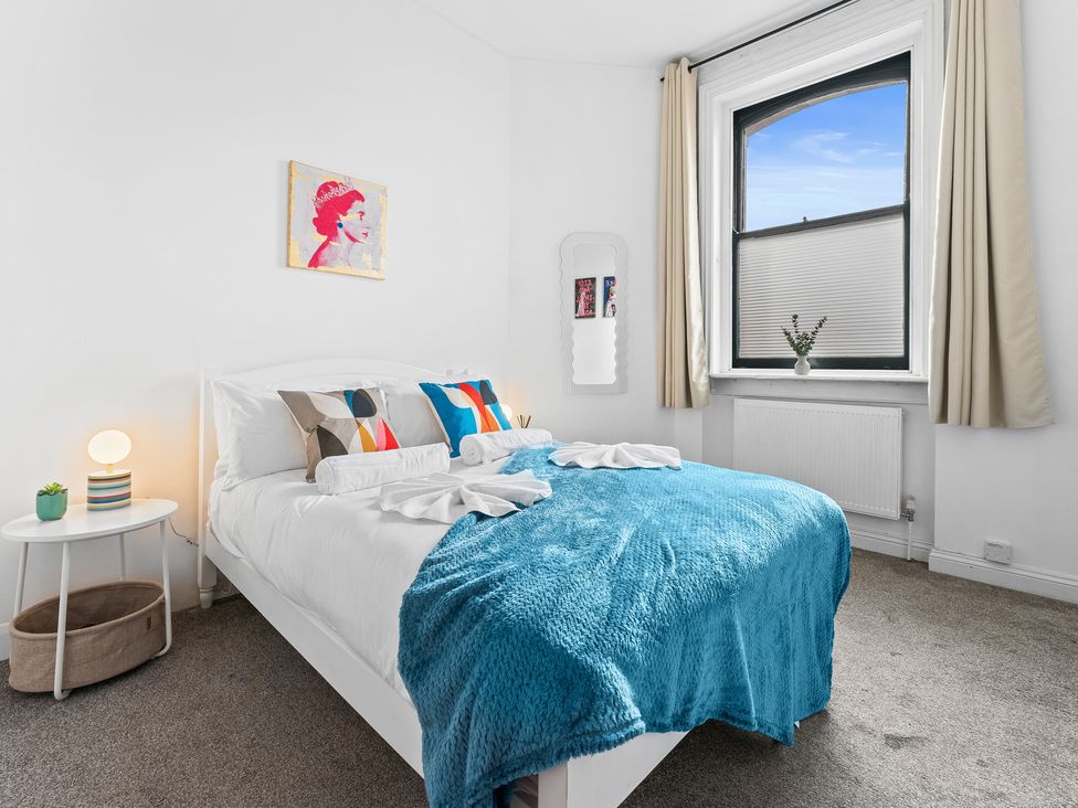 A bedroom with a bed and decorative items at The Gilder Birmingham City Apartment in Birmingham