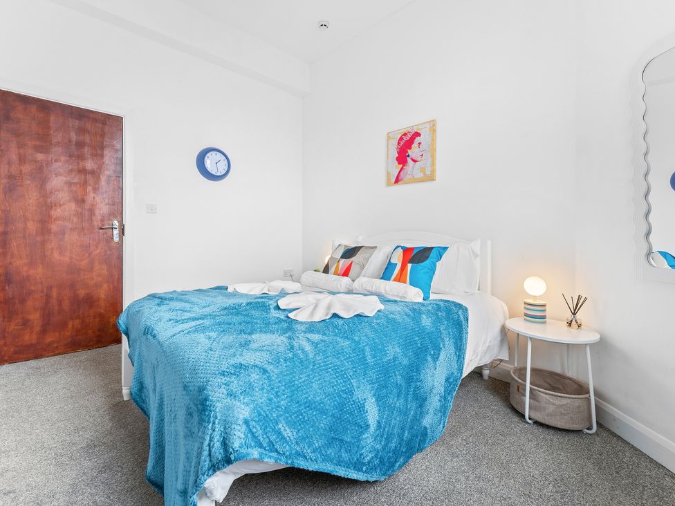A bedroom with a bed and bedside table at The Gilder Birmingham City Apartment Birmingham