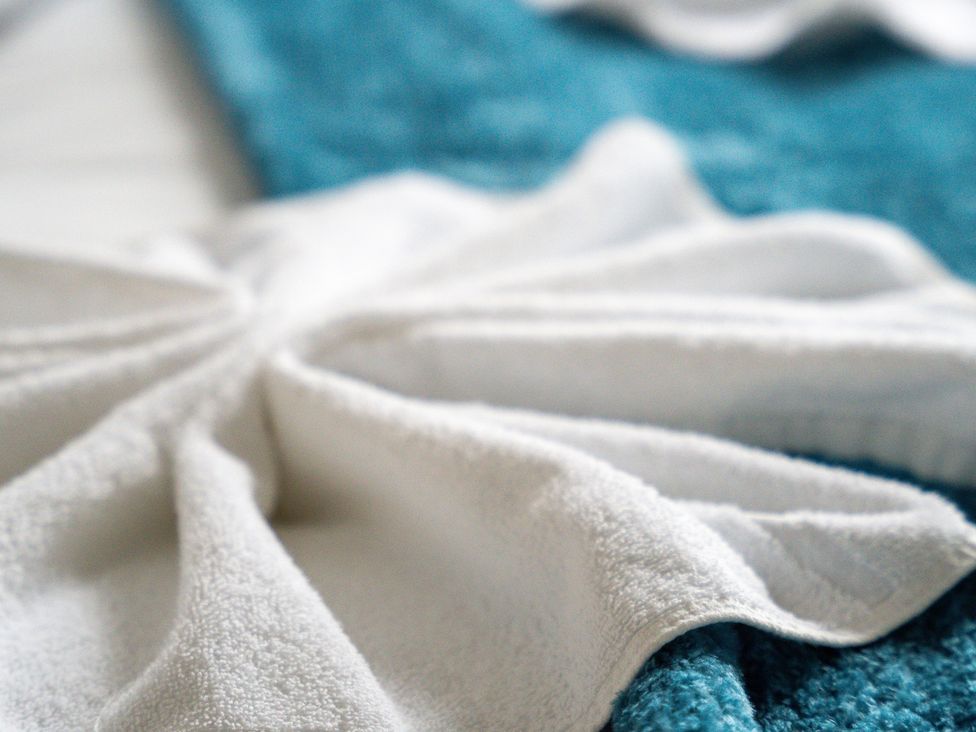 A towel arranged decoratively on a bed at The Gilder Birmingham City Apartment Birmingham