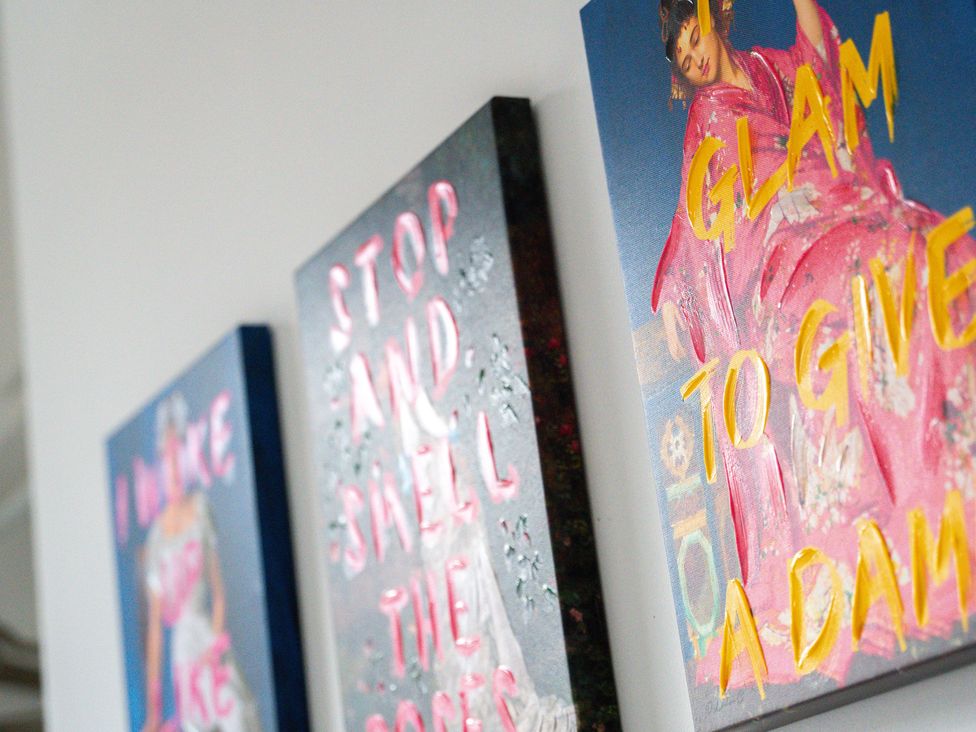 Three wall art pieces with various text at The Gilder Birmingham City Apartment in Birmingham