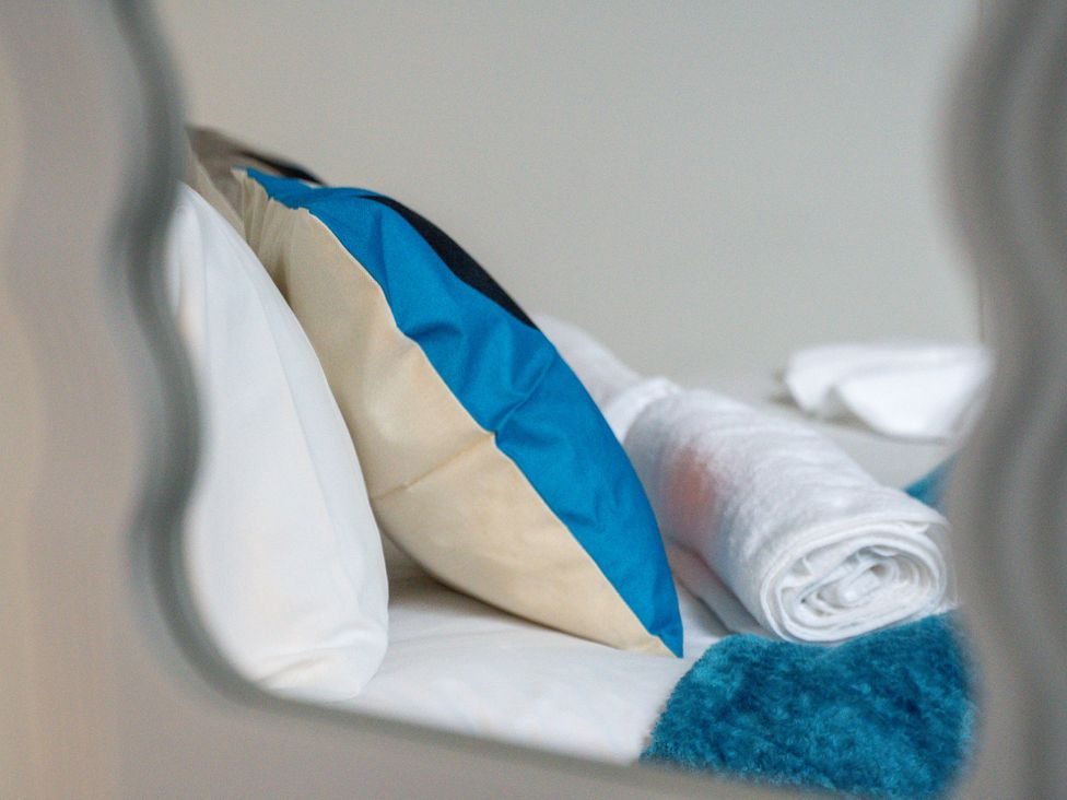A bedroom with a pillow and a rolled towel at The Gilder Birmingham City Apartment, Birmingham
