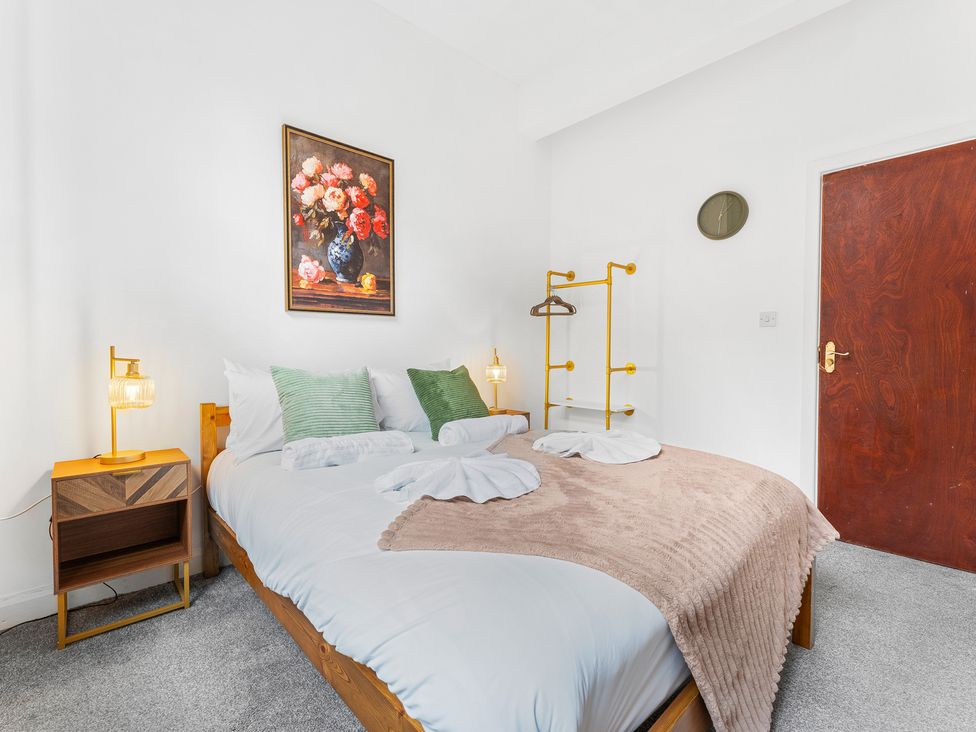 A bedroom with a bed and nightstand at The Gilder Birmingham City Apartment in Birmingham