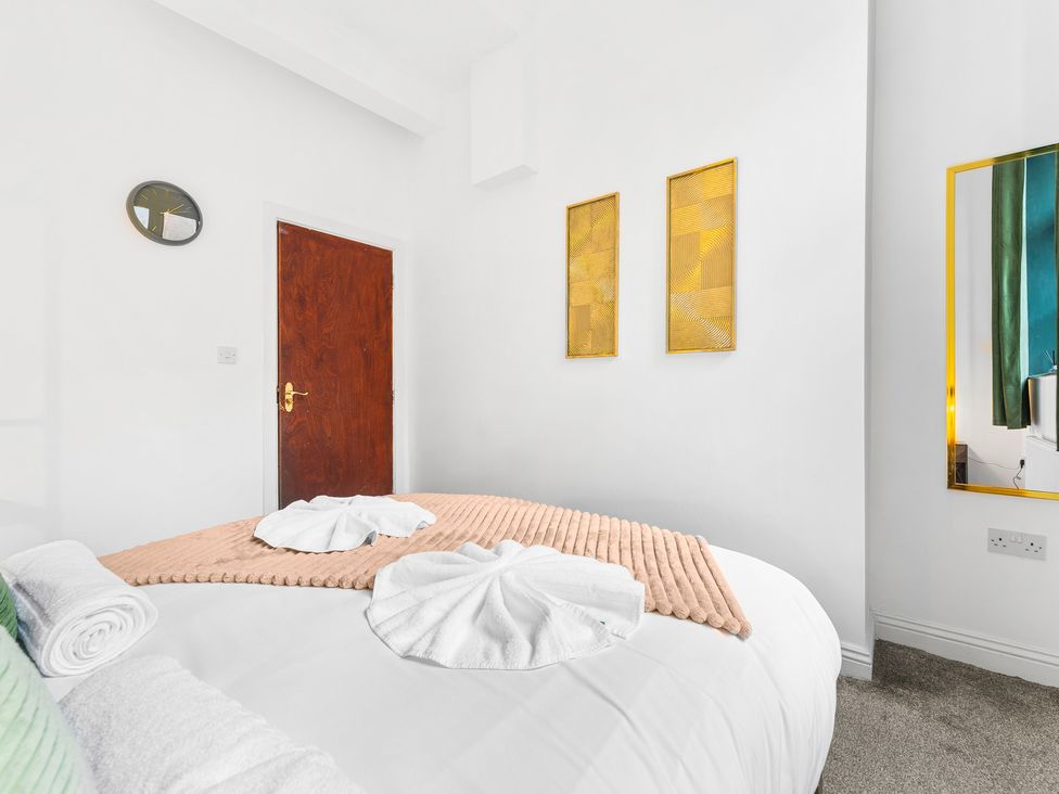 A bedroom with a bed and wall art at The Gilder Birmingham City Apartment Birmingham