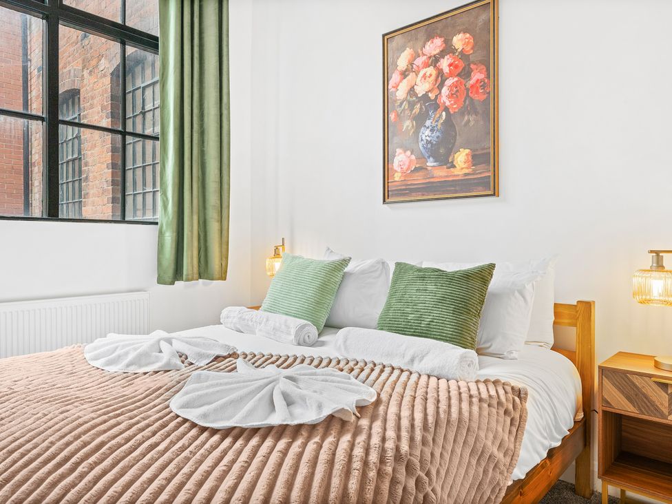 A bedroom with a bed and decorative items at The Gilder Birmingham City Apartment Birmingham
