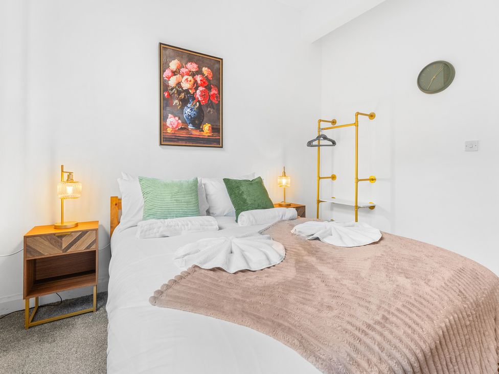 A bedroom with a bed and bedside table at The Gilder Birmingham City Apartment Birmingham