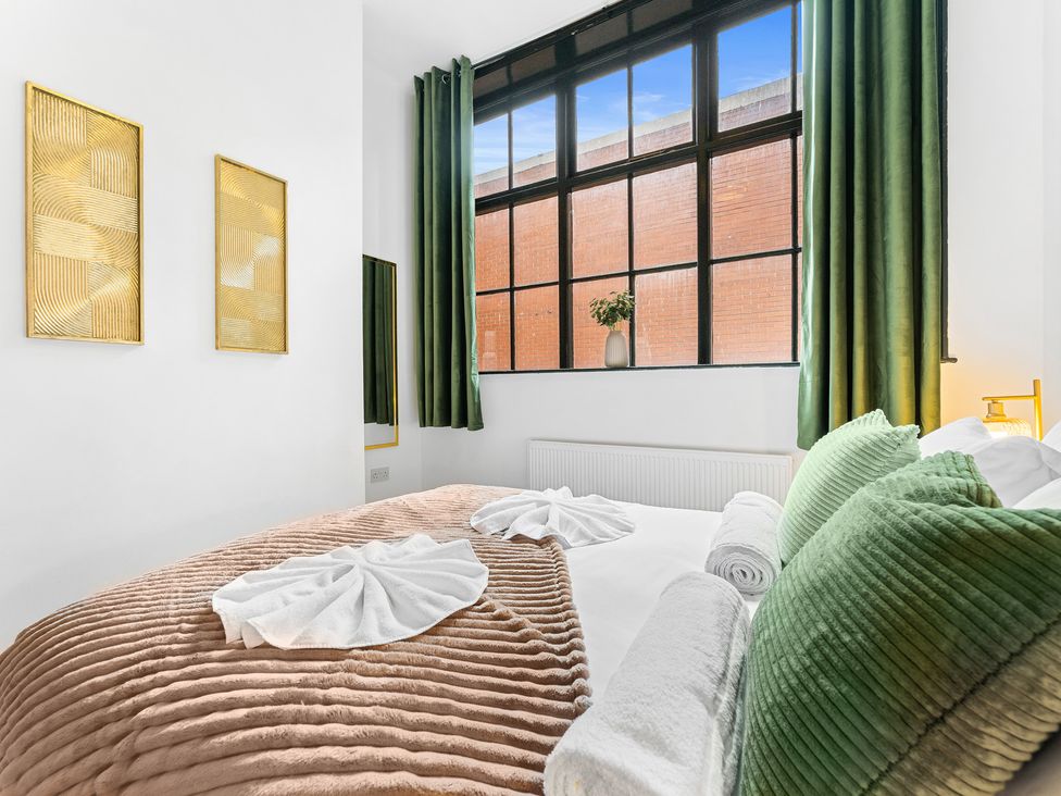 A bedroom with a bed and curtains at The Gilder Birmingham City Apartment Birmingham