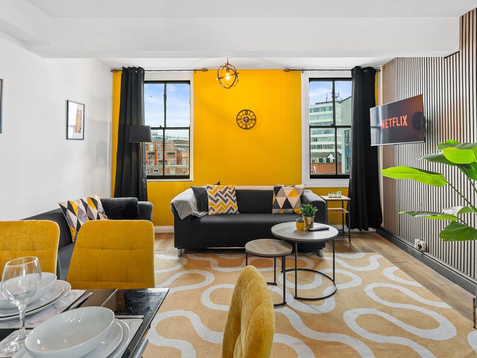 A living room with a sofa and coffee table at The Craftsman Birmingham City Apartment in Birmingham