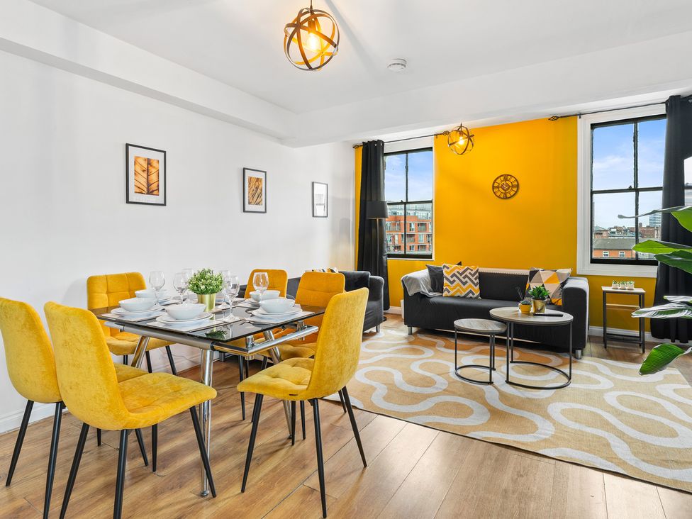 A dining room with a table and chairs at The Craftsman Birmingham City Apartment Birmingham