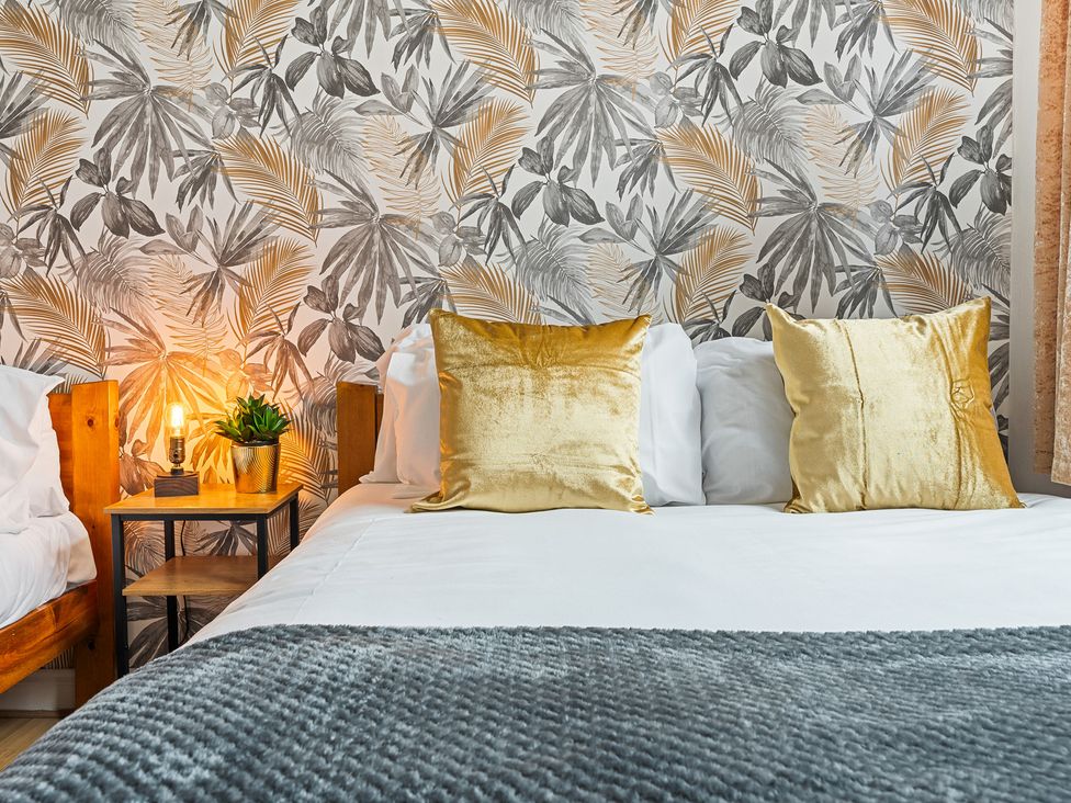 A bedroom with a bed and decorative pillows at The Craftsman Birmingham City Apartment Birmingham