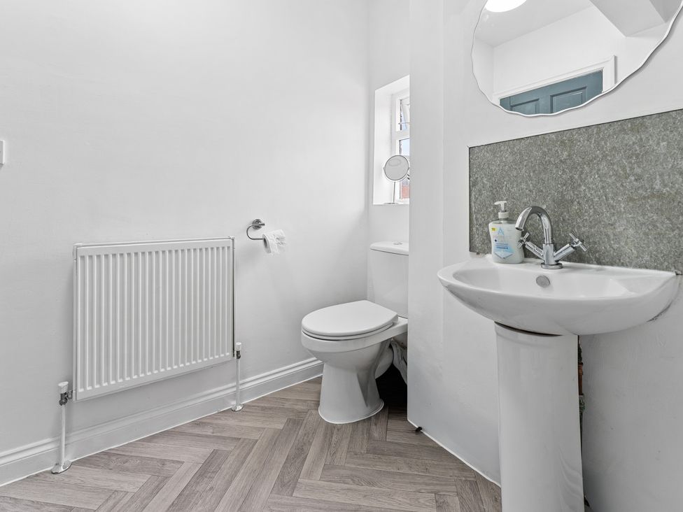 A bathroom with a toilet and sink at The Craftsman Birmingham City Apartment Birmingham
